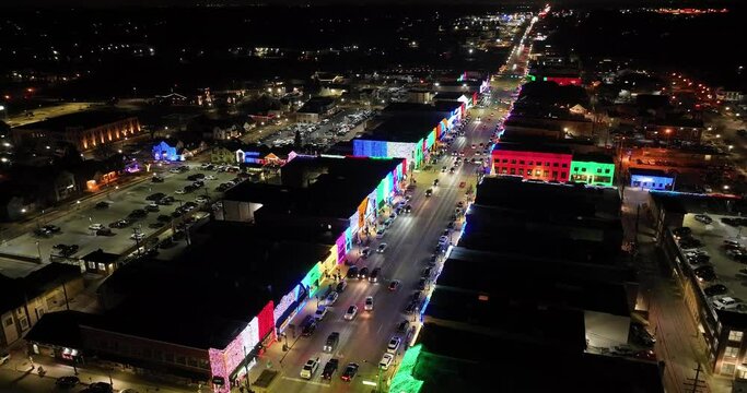 Rochester, Michigan skyline at night lit up with Christmas lights on buildings and drone video circling.