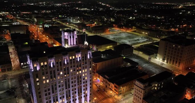 Flint, Michigan at night skyline with drone video circling.