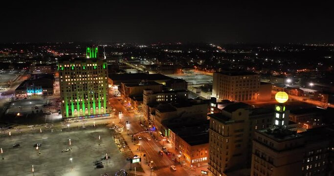 Flint, Michigan at night skyline with wide shot drone video moving sideways.