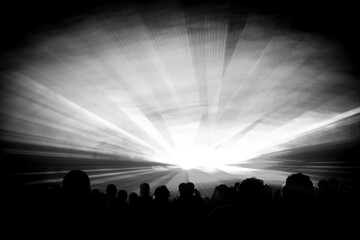Grey laser show nightlife club stage with party people crowd. Luxury entertainment with audience silhouettes in nightclub event, festival or New Years Eve. Beams and rays shining colorful lights
