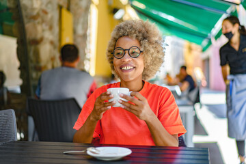 drinks and people concept - happy woman with cup drinking cafe at city street cafe terrace