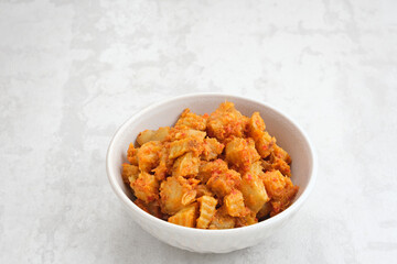 Sambal Goreng Kentang (stir-fried potatoes with spices), Indonesian traditional food. Served in white bowl.
