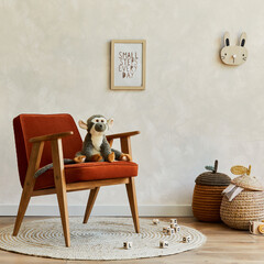 Stylish composition of cozy scandinavian child's room interior with bed, red armchair, plush and wooden toys and textile hanging decorations. Creative wall, carpet on the floor. Copy space. Template. © FollowTheFlow