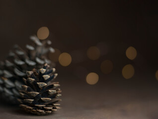 Pine cone isolated on light background. Holiday glowing backdrop. Defocused background with...