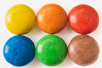 Colorful chocolate candies on white background close-up view