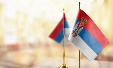 Small flags of the Serbia on an abstract blurry background
