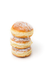 Stack of Krapfen, Kreppel or Berliner doughnuts dusted with powdered sugar on white background, traditional German fried Brioche dough pastry filled with vanilla custard or jam for New Year's party - 556941493
