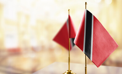 Small flags of the Trinidad and Tobago on an abstract blurry background