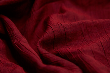 Blur red fabric background. Red cloth waves background texture. Red fabric cloth textile material.