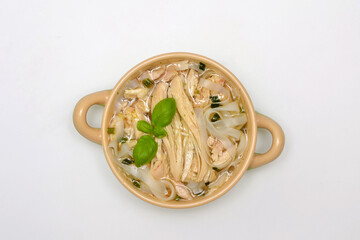 soup with chinese noodles and chicken on a white background, top view