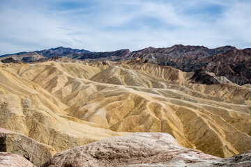 Fototapeta na wymiar Zabriskie Point. It is a part of the Amargosa Range located east of Death Valley in Death Valley National Park in California, United States, noted for its erosional landscape. USA