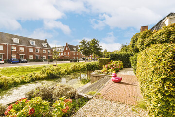 some houses and flowers in the fore - image is taken from an angleer's perspective, with blue sky...
