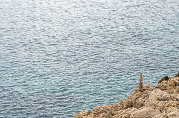 Stone pyramid. Pebbles balance pile, harmony zen stones, balance stack, sea pebble pyramid on shoreline, relaxation