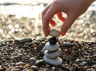 Stone pyramid. Pebbles balance pile, harmony zen stones, balance stack, sea pebble pyramid on...