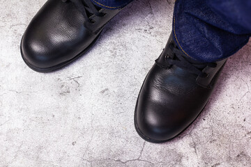 Wear safety shoes to ensure safety at work. construction workers wear safety shoes. concept construction workers work on the stairs.