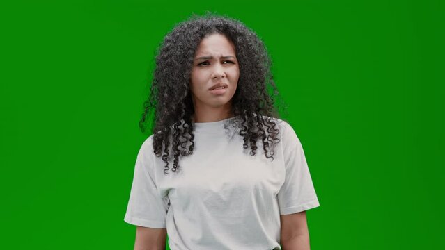 puzzled and clueless woman scratching her head express misunderstanding Isolated on Green Screen