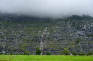Switzerland, Bern, Urbachtal, Green pastures and rock face