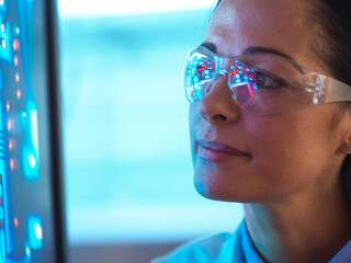 Scientist in glasses looking at screen