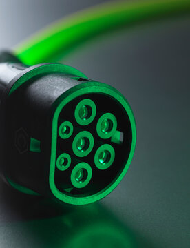 Studio shot of green electric car charging cable