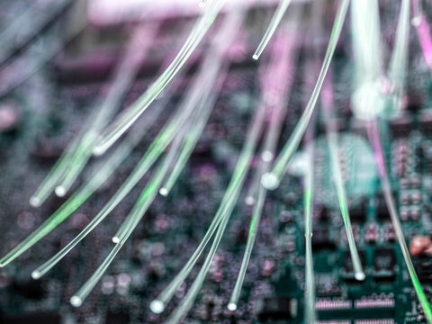 Close-up of fibre optics carrying data being transferred to desk top computer