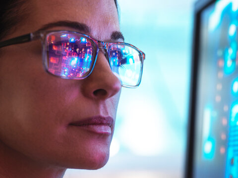 Scientist in glasses looking at screen