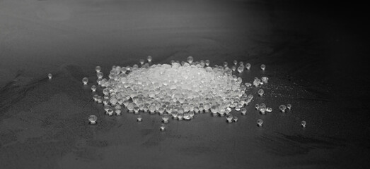Desiccant Silica Gel Adsorbent Crystals on Black Background, Desiccant Polymer Balls