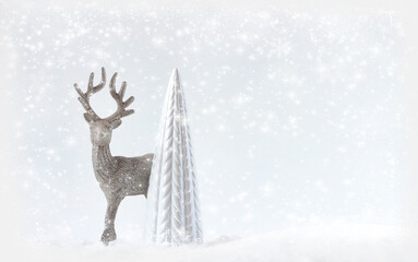 The figure of a reindeer, a deer stands near the Christmas tree, the decor of a Christmas card.