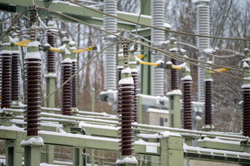 Electrical substation ceramic insulators covered with snow