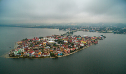 Flores island in Guatemala. Morning Misty Light with Lake Peten Itza in background