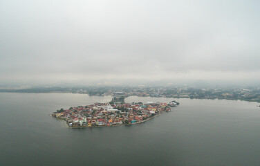 Fototapeta premium Flores island in Guatemala. Morning Misty Light with Lake Peten Itza in background