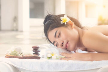 Fototapeta na wymiar Beautiful asian woman lying with happy mood on vacation day.Wellness body care and spa aromatheraphy concept.