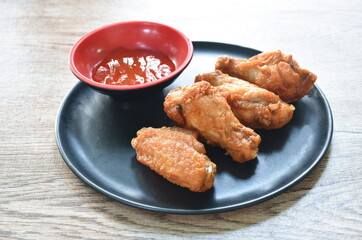 crispy fried chicken drumstick and wing dipping chili sauce arranging on plate
