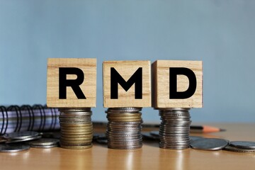 RMD concept, Required minimum distribution concept on wooden blocks.