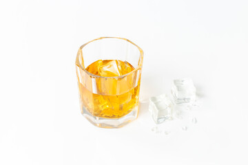 Golden whiskey in glass with ice. Strong alcohol background