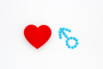 Male sign made of blue pills with red heart. Male medical checkup concept