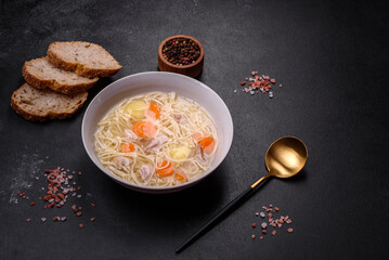 Delicious soup with noodles, chicken and carrots with spices and herbs