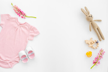 Fototapeta na wymiar Newborn baby bodysuit with rabbit toy, flat lay, top view