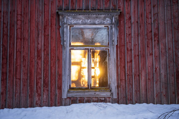 Sunlight shining through old windows. Old house with red walls. Österbotten/Pohjanmaa, Finland
