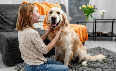 Preteen girl child with golden retriever dog