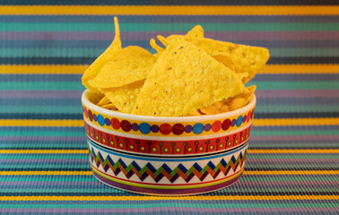 Delicious nachos with cheese on the white wooden background stock photo. Bowl tortilla chips stock photo. Mexican nachos with cheese. Corn chips isolated on wooden background stock photo.