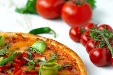 vegetarian pizza with cheese, tomato, pepper and avocado in white wooden desk.Top view