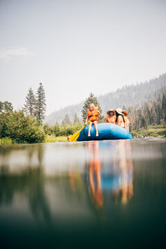 USA, California, Family rafting on calm Truckee river