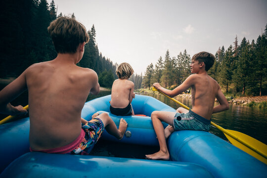 USA, California, Boys rafting on Truckee river