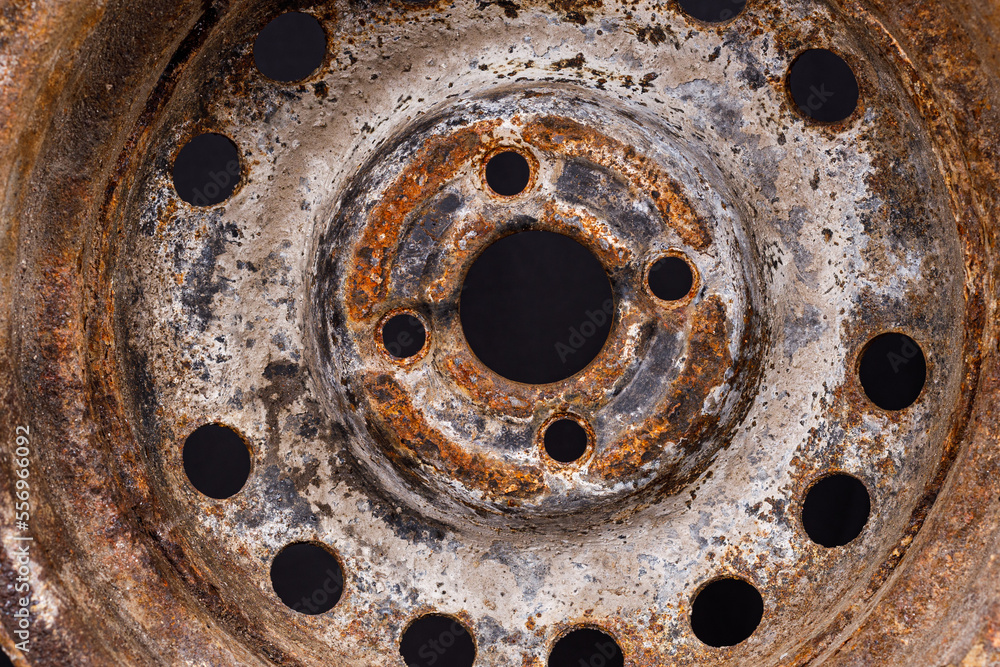 Poster old car rim with rust close-up on a black background