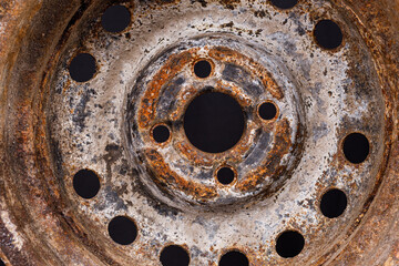 old car rim with rust close-up on a black background