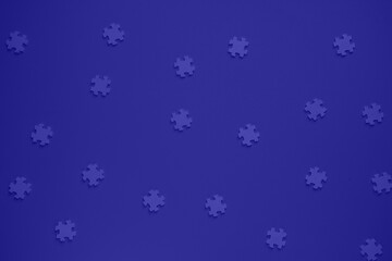 Flat blank wooden puzzles on a blue background view from above. Festive background for a congratulatory inscription. New Year, Christmas, Holy Valentine. Festive decor. Blurred background