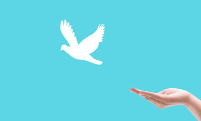 hand praying and birds free enjoying nature on light blue background hope and freedom concept