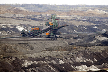 An huge excavator on a coal surface mine. Interesting geological forms of tailings dump in an open pit coal mine.	