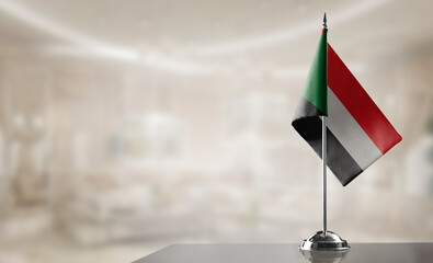 A small Sudan flag on an abstract blurry background