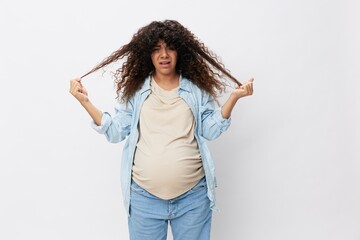 Pregnant woman hair loss during pregnancy, health problems and vitamin deficiencies on a white isolated background in a t-shirt with a blue shirt